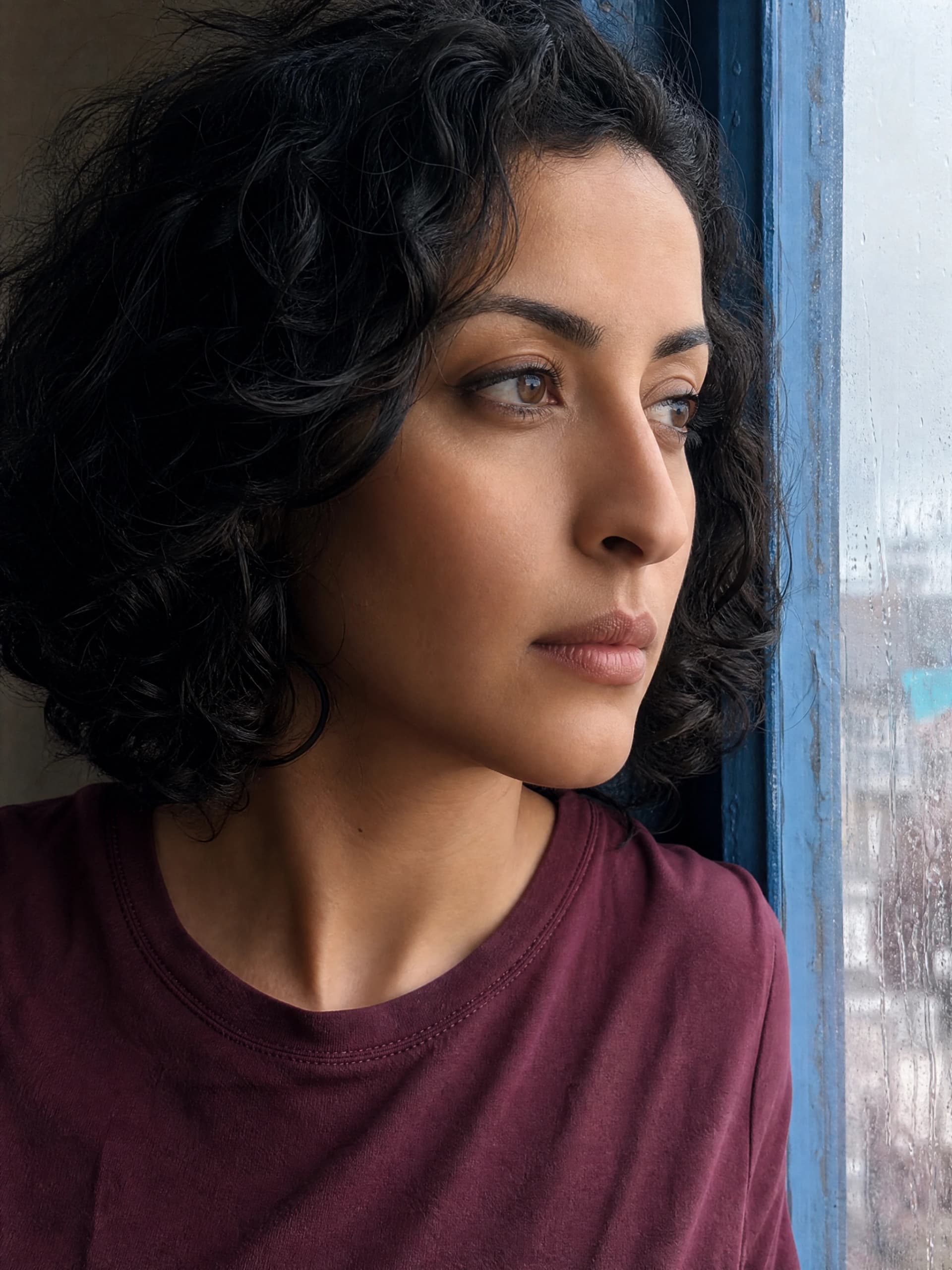 Shared fictional adult creator reference: curly dark bob, olive skin and burgundy shirt