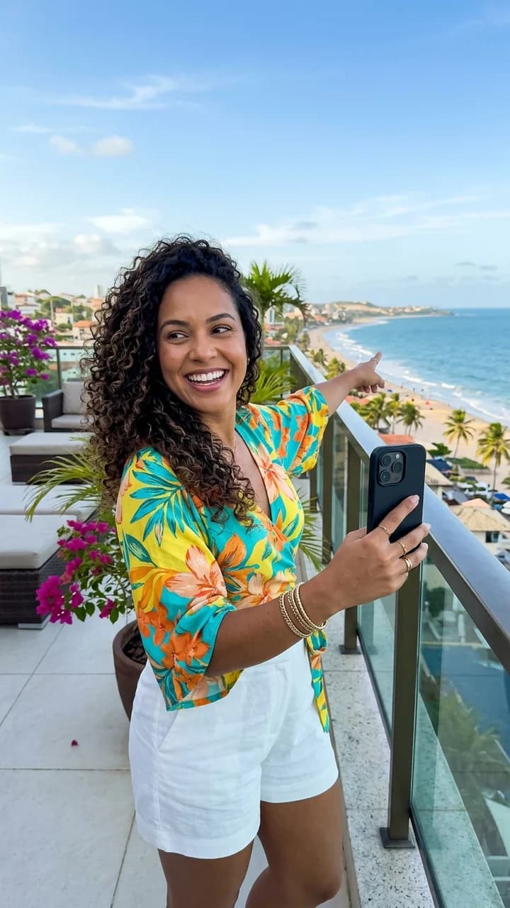 Yara Santos, a fictional adult human travel creator, turning the camera toward a balcony view while giving a hotel tour