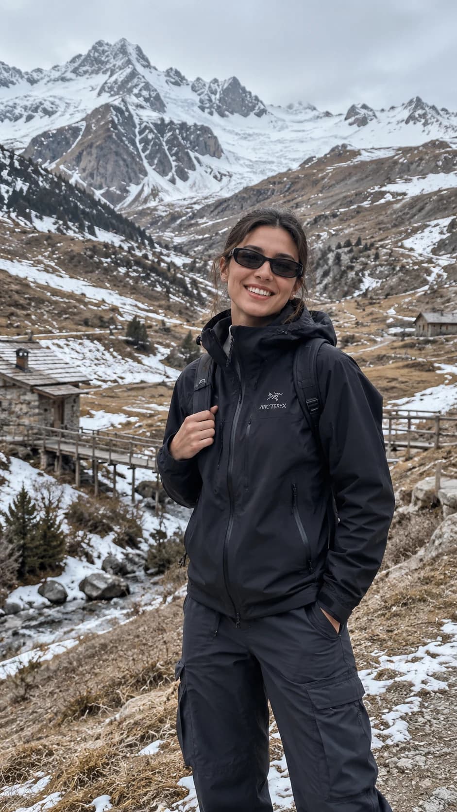 Virtual hiker gripping a backpack strap beneath snowy mountain peaks