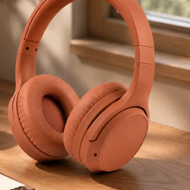 Actual product-reference close-up showing terracotta earcup, cushion and yoke geometry
