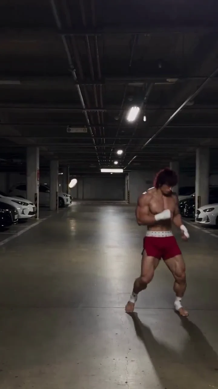 Actual frame at 5 seconds of the Baki video shared on X, used to inspect a training pose and limb placement in a parking garage.