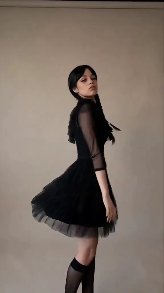 Friday Adams source dance at 8.5 seconds showing a body turn, moving skirt and three-quarter face