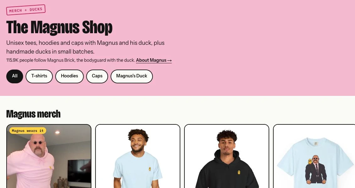 Magnus Brick official merchandise shop with the pink hoodie, duck-emblem T-shirt, black hoodie and character-illustration tee