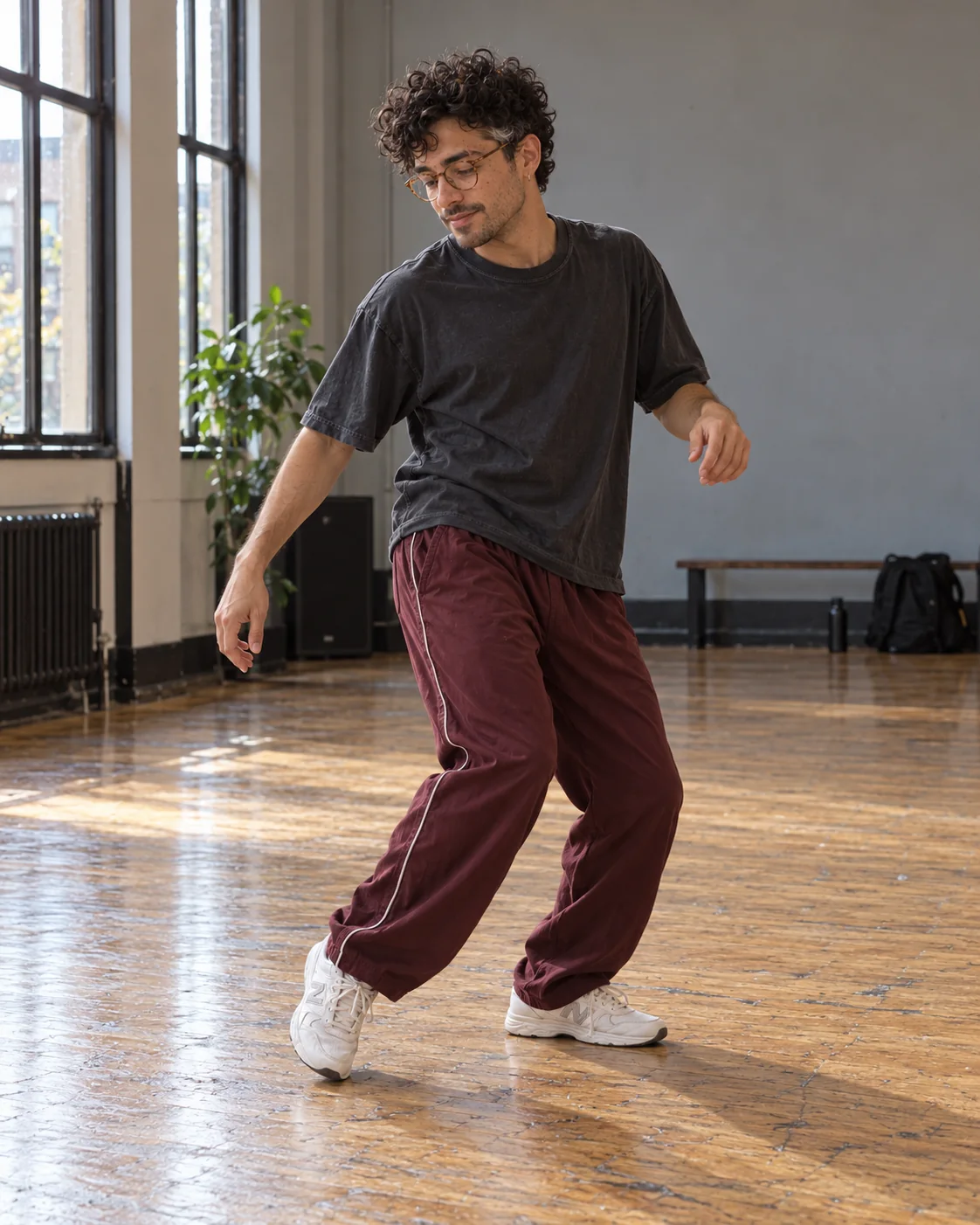 Full-body AI dance storyboard still of Eli practicing a side-step with his feet visible