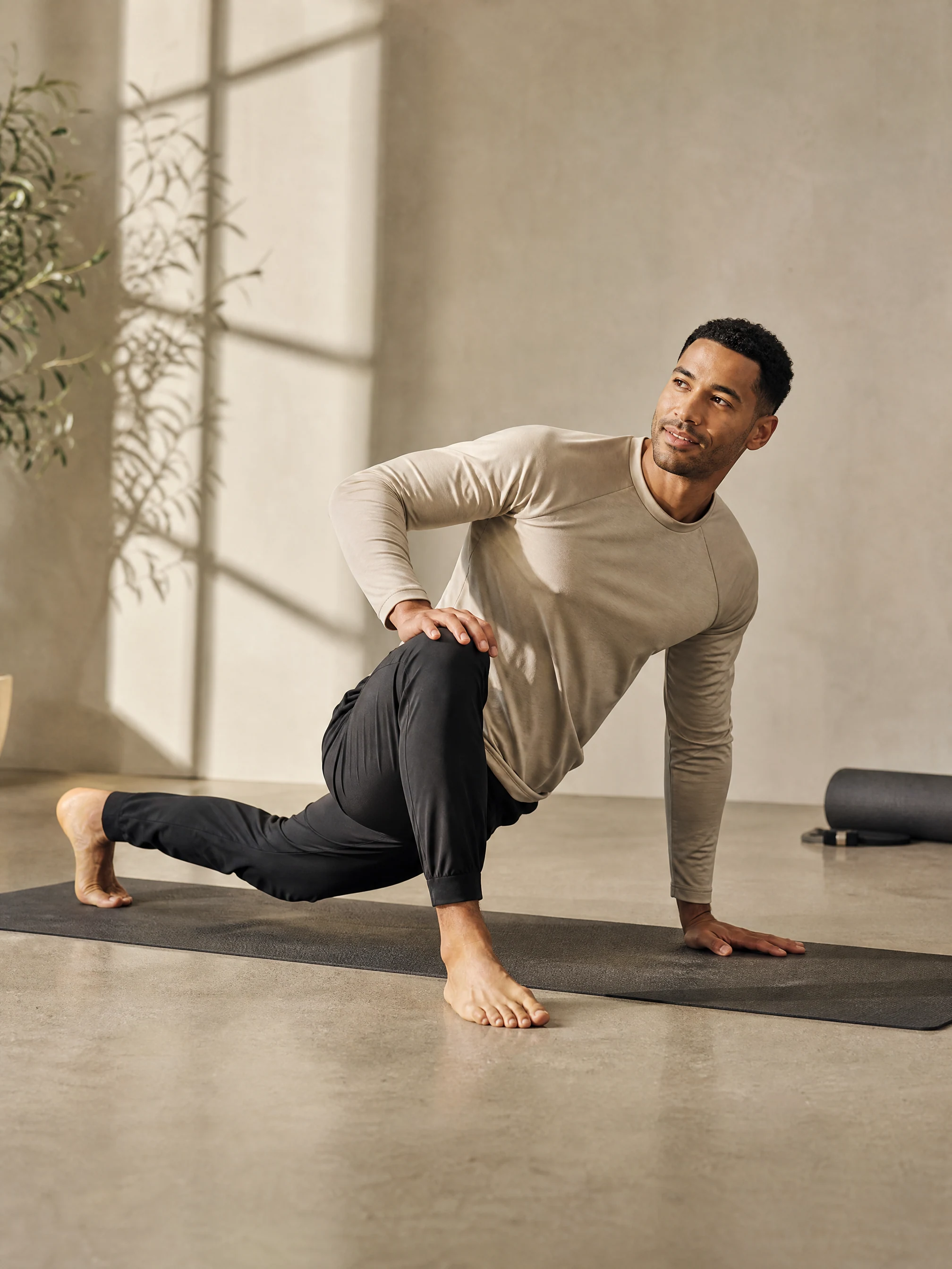 A fictional adult male fitness creator in a quiet mobility-inspired campaign scene.